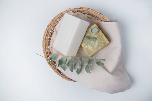 A natural, eco-friendly soap set with eucalyptus in a wicker basket, perfect for organic lifestyle promotions.