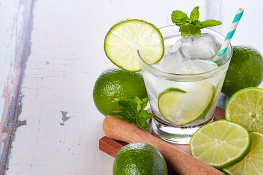 Chilled lime cocktail with mint and ice in a glass. Perfect for summer refreshment.