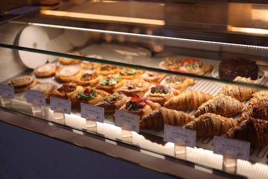 A tempting display of assorted pastries and croissants in a bakery showcase.