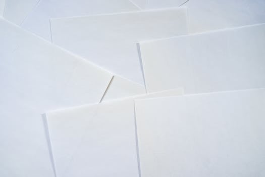 Abstract image featuring overlapping sheets of white paper creating geometric textures.