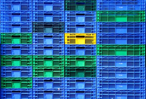 Colorful plastic crates stacked in a vibrant pattern at Tel Aviv market.