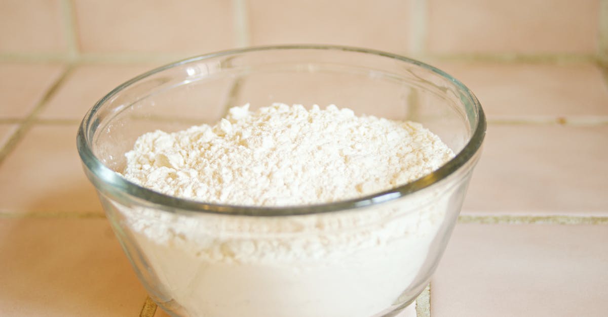 Close-up of a glass bowl filled with white flour, a common baking ingredient.