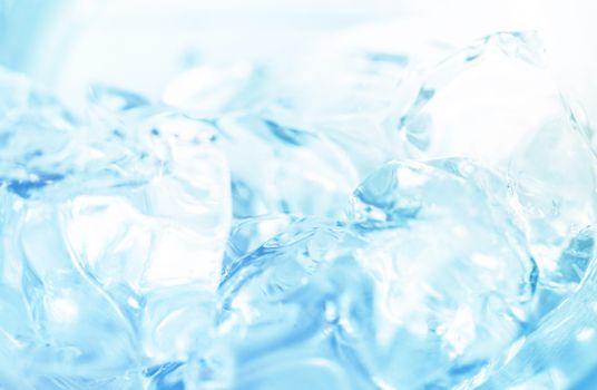 Abstract close-up of ice cubes against a bright blue background, capturing the essence of freshness.