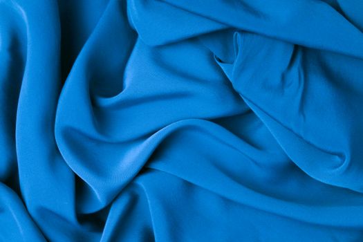 Luxurious blue cloth texture with a soft and crumpled appearance.